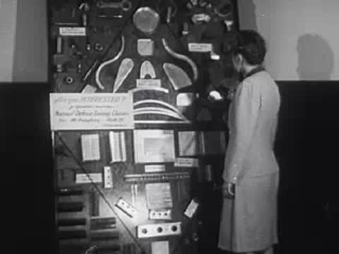 Person looking at a wall covered with notices, schedules, and diagrams