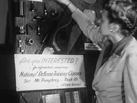 Woman reading a notice on a board reading "Are you INTERESTED?"