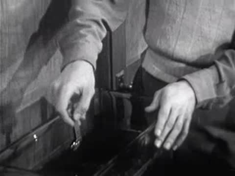 close-up of hands placing object into liquid tank