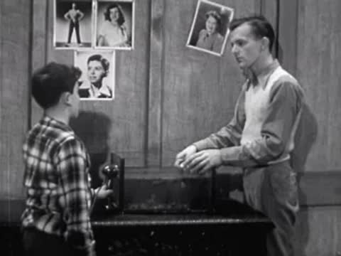 boy and man talking in workshop near apparatus