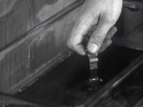 close-up of object being lowered into water tank