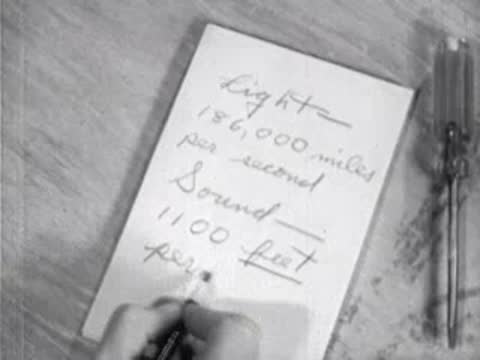 close-up of paper showing written light and sound speeds