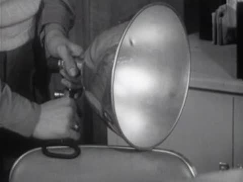 close-up of hands adjusting megaphone reflector dish