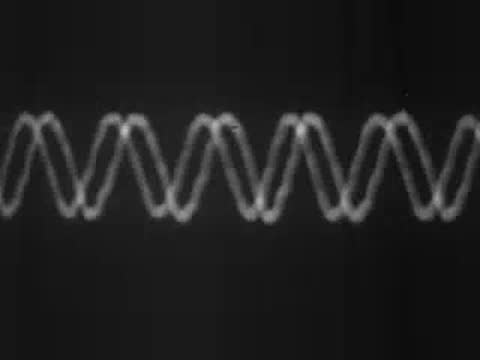 Oscilloscope screen displaying sound waves changing in frequency and amplitude