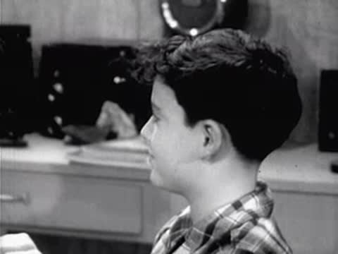 profile shot of a young boy looking at an experiment
