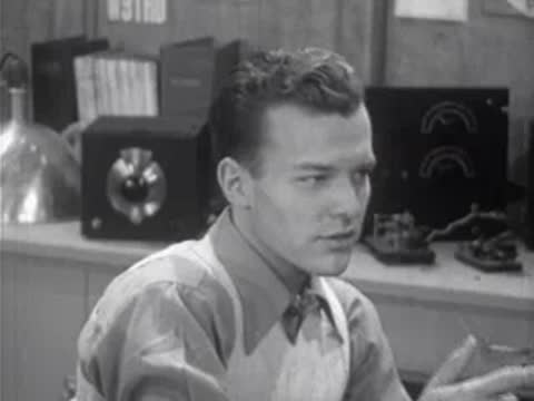 adult speaking to someone off-camera in a laboratory setting