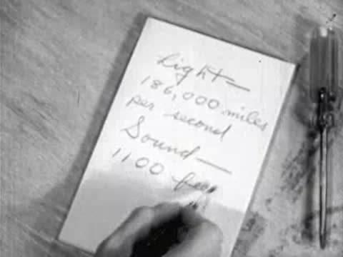 hands writing speed of light and sound statistics on a pad