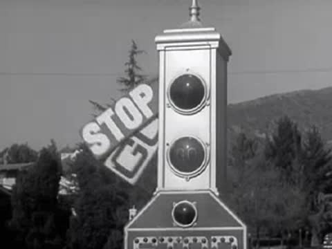 A traffic signal with arms reading GO and STOP flips between settings.