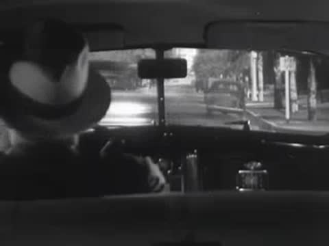 View from inside a car as it passes an intersection.