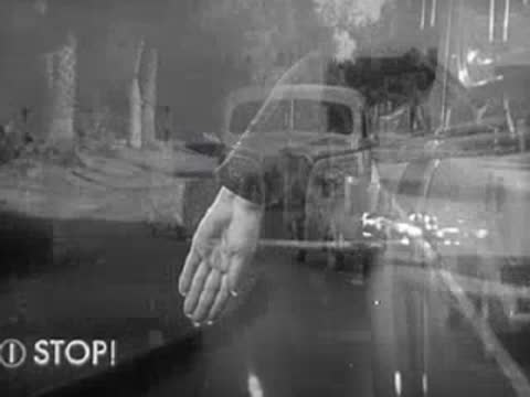 Superimposed images of hand signals and driving vintage car.