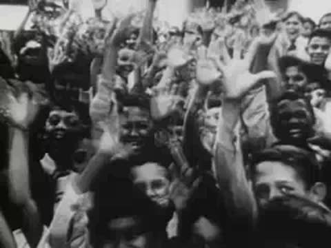 crowd of diverse people and children cheering and waving hands excitedly
