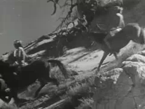 Horse riders navigating a steep rocky hillside