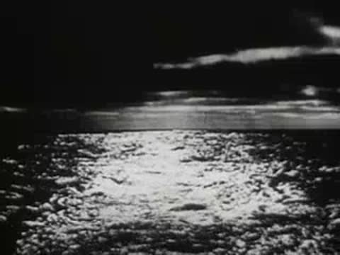 sparkling sunlight reflecting off the surface of open ocean water at night