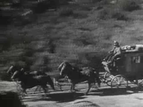 a horse-drawn carriage speeding along a dusty dirt road through a landscape