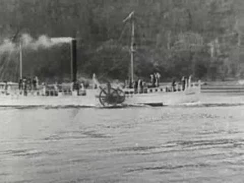 paddle steamer boat moving along a calm river or canal