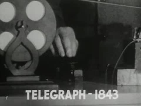 telegraph machine operating with paper tape and spool mechanism in an office