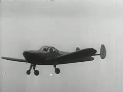 Modern single-engine airplane taking off and flying low over a grassy airfield, aviation
