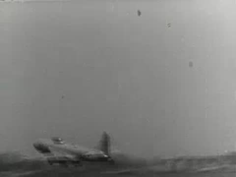 Military jet fighter aircraft taking off from a runway, mid-20th century footage.