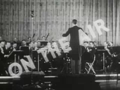 Stylized 'ON THE AIR' graphic title overlaying an orchestra performing on stage.