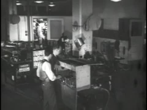 Engineers working on electronic equipment in a laboratory.
