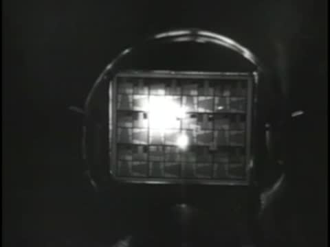 Camera capturing a test pattern through a glass lens apparatus.