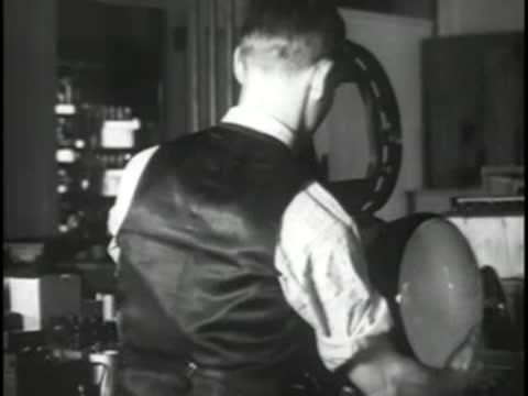 Technician working with electronic gear in a laboratory setting.