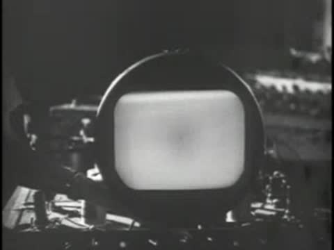 A spherical oscilloscope or CRT display lights up with a test pattern.