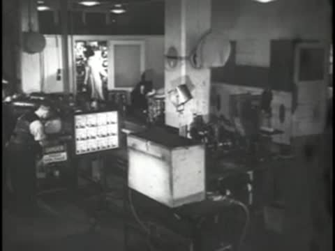 Interior view of a television control room with monitors and equipment racks.