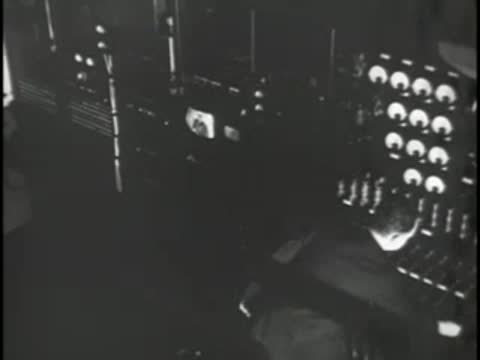 A telephone switchboard or equipment rack with glowing indicator lights.