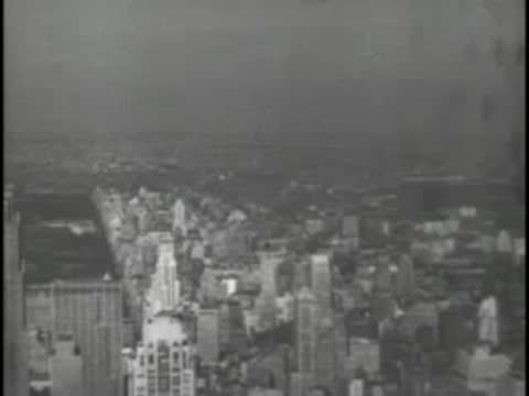 Aerial or high-angle view of a cityscape with buildings under hazy skies.