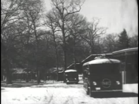 A mobile television broadcast van drives through a tree-lined area.