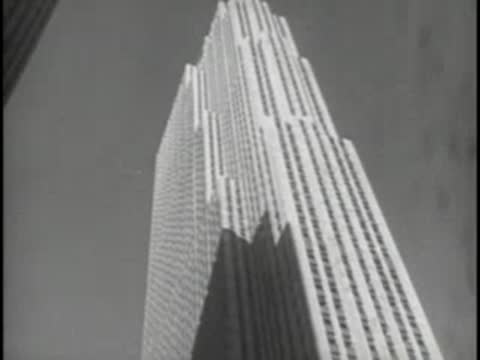 Low angle shot of the Empire State Building towering above.