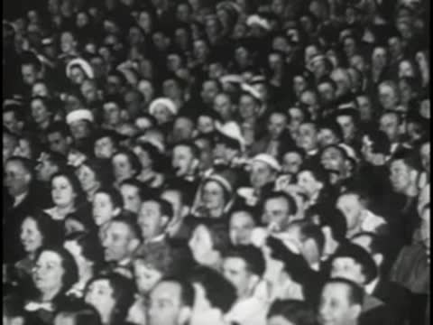 Close-up crowd of people watching an event together.
