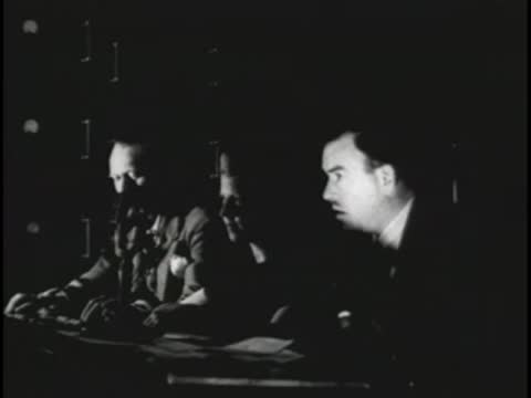 Control room monitors showing a live orchestra performance in the studio.