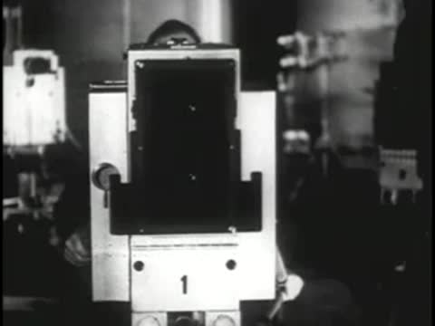 Large vintage television broadcast camera on a studio dolly being operated.