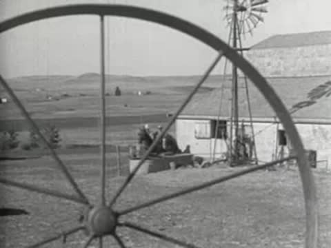 A windmill turning in front of a rural landscape, prelinger archive footage