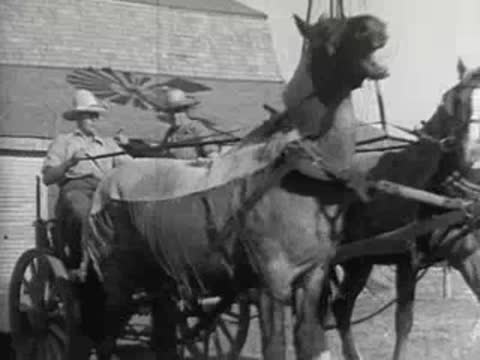 A horse-drawn cart pulling away, historic footage of agricultural life