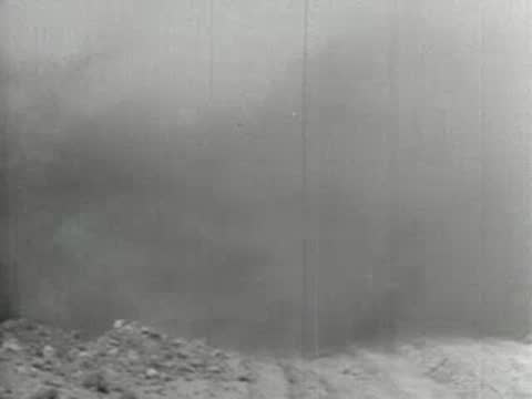 Wide shot of a massive cloud of dust sweeping low across the ground, 1930s