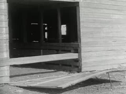 A wooden loading ramp leading up to the doorway of a barn structure