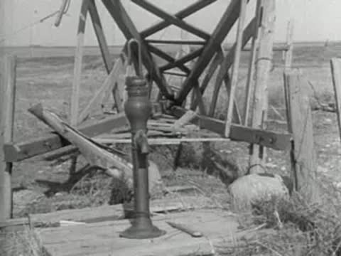 A water pump mechanism and wooden framework in an open field