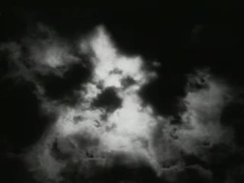 Dramatic white clouds moving across dark sky, time lapse feel.