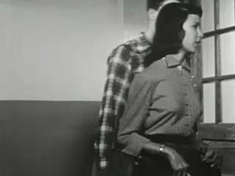 Students talking in a high school hallway, mid-century fashion