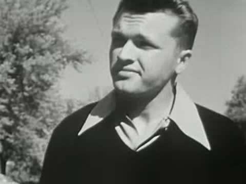 Close-up of a young man outdoors with trees in the background