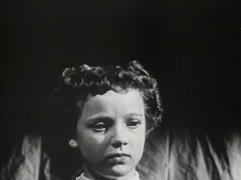 Close-up of a young girl looking thoughtful in a hallway