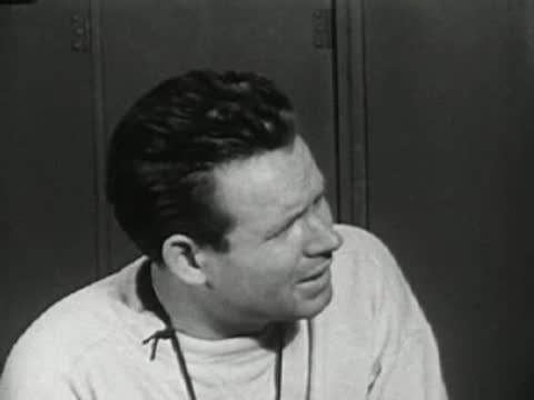 Close-up of coach talking seriously in the locker room.