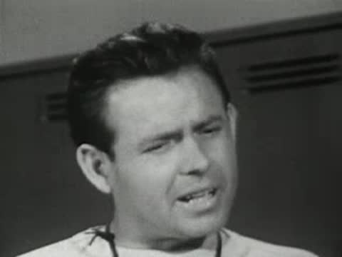 Close-up of coach speaking in the locker room.