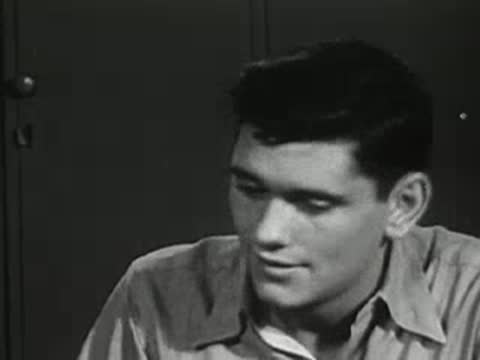 Close-up of teen boy responding in the locker room.