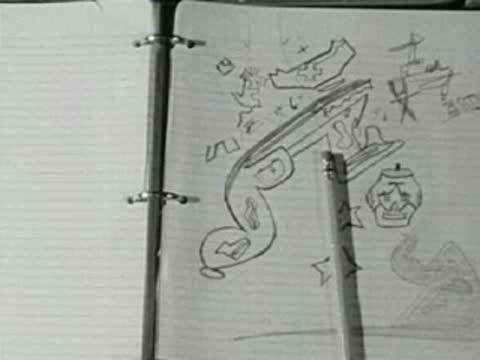 Close-up of hand-drawn illustrations in a notebook with doodles and notes.