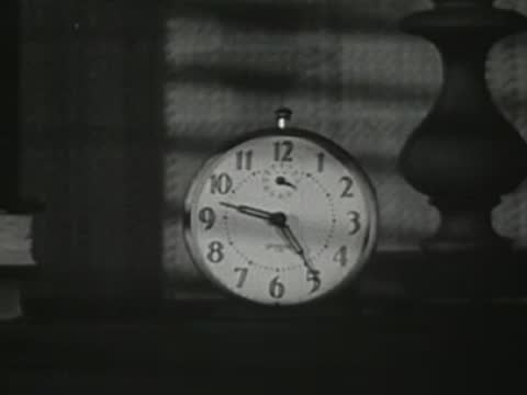 Alarm clock on a bedside table showing morning time.