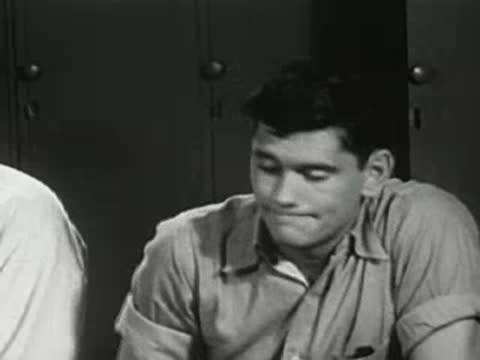 Close-up of a young man talking in what appears to be a locker room setting.